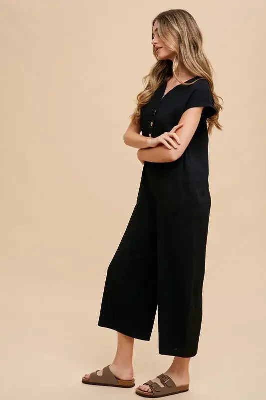 Black cropped wide leg jumpsuit with short sleeves and button-down front from Annie Wear