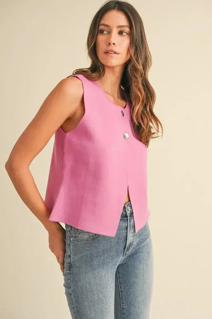 Pink sleeveless crop sweater vest with metal button detail and split hem