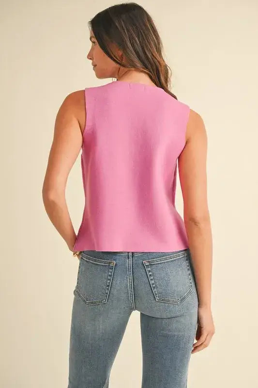 Women’s pink sleeveless crop sweater vest with metal button detail from Annie Wear