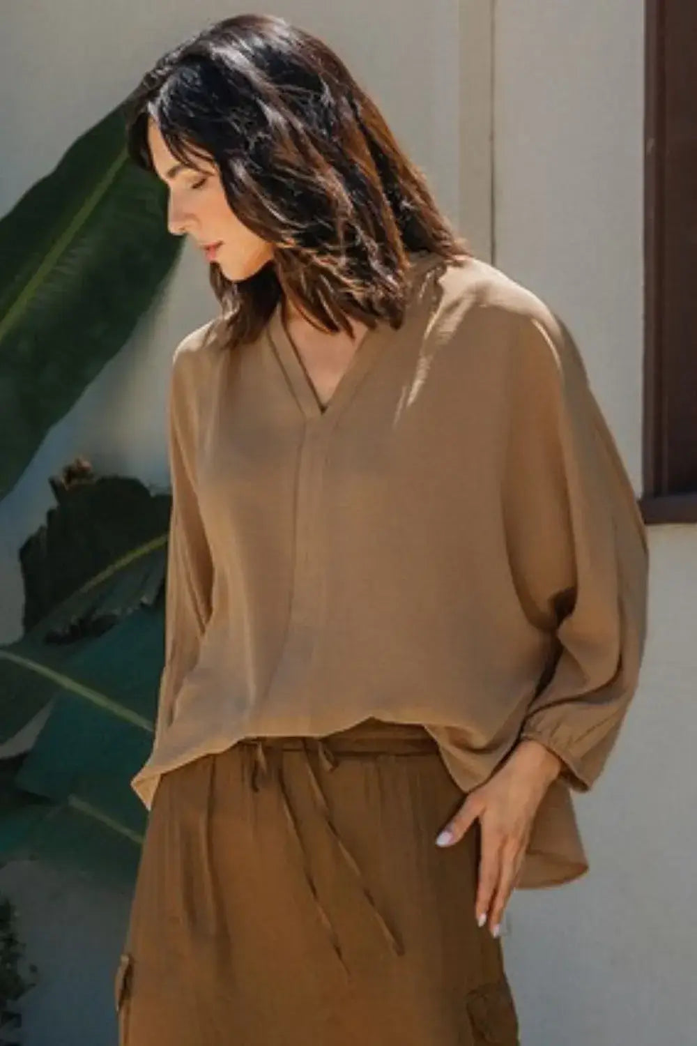 Beige silk notched batwing sleeve blouse with long sleeves and V-neck design