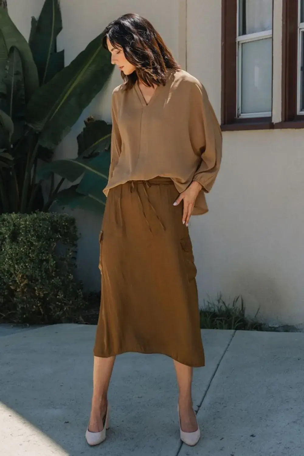Brown silk wrap skirt with side slit and pockets paired with Annie Wear notched batwing sleeve blouse