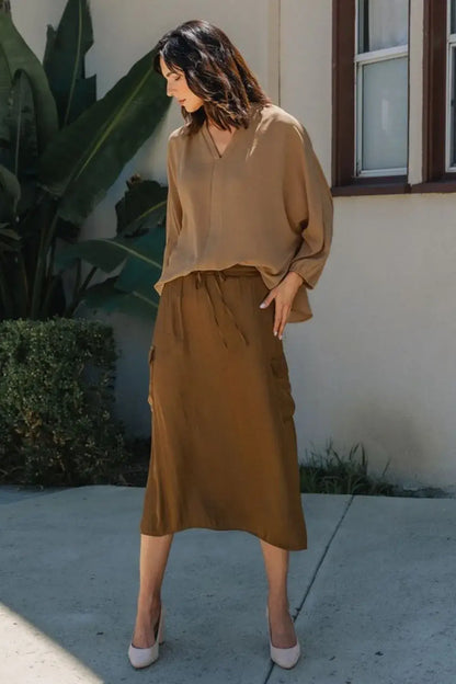 Brown silk wrap skirt with side slit and pockets paired with Annie Wear notched batwing sleeve blouse