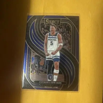 Basketball trading card featuring Anthony Edwards in white Timberwolves uniform from Panini Select Premier Level Blue Cracked Ice Prizm