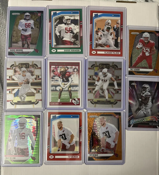 Arizona Cardinals cardinals RC lot featuring trading cards in protective sleeves