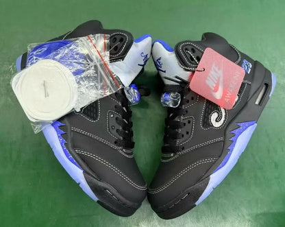 Black and blue Air Jordan 5 sneakers with white stitching and translucent sole for fast shipping