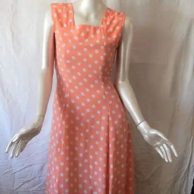 Peach polka dot maxi dress on mannequin with white polka dots for summer style