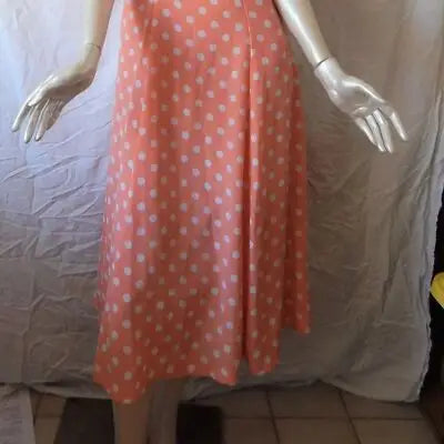 Mannequin wearing B.T.N. Coral sleeveless dress with white polka dots, retro summer style