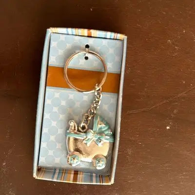 Silver-toned baby carriage charm keychain with light blue accents in gift box