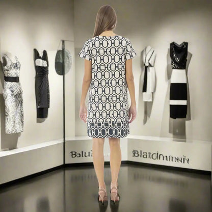 Woman modeling Baldinini Trend black and white graphic print dress with geometric pattern