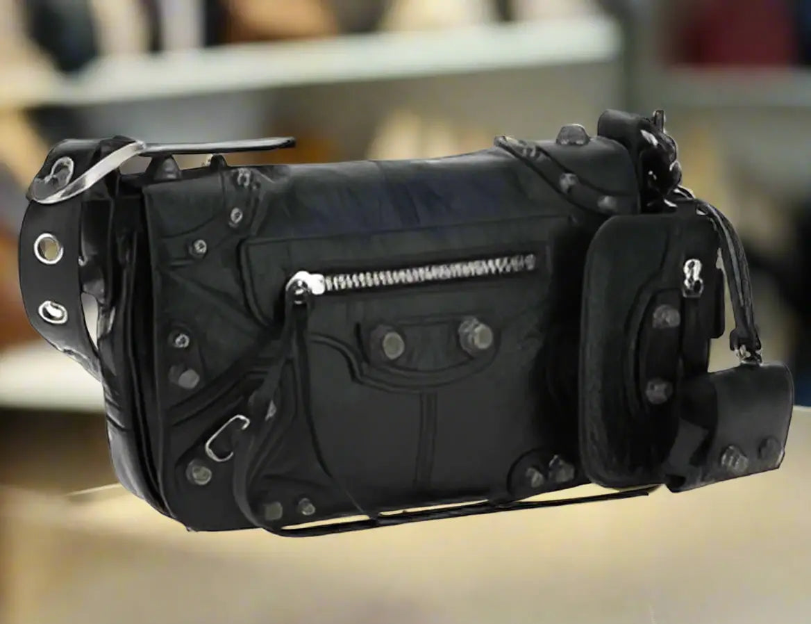 Black leather Cagole shoulder bag with silver hardware, studs, and accessory pouches
