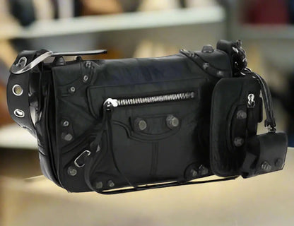 Black leather Cagole shoulder bag with silver hardware, studs, and accessory pouches