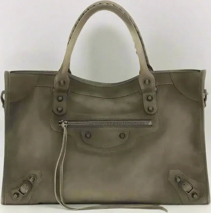 Grey patent leather tote bag with braided handles, studs, and front zipper pocket for city medium handbag style