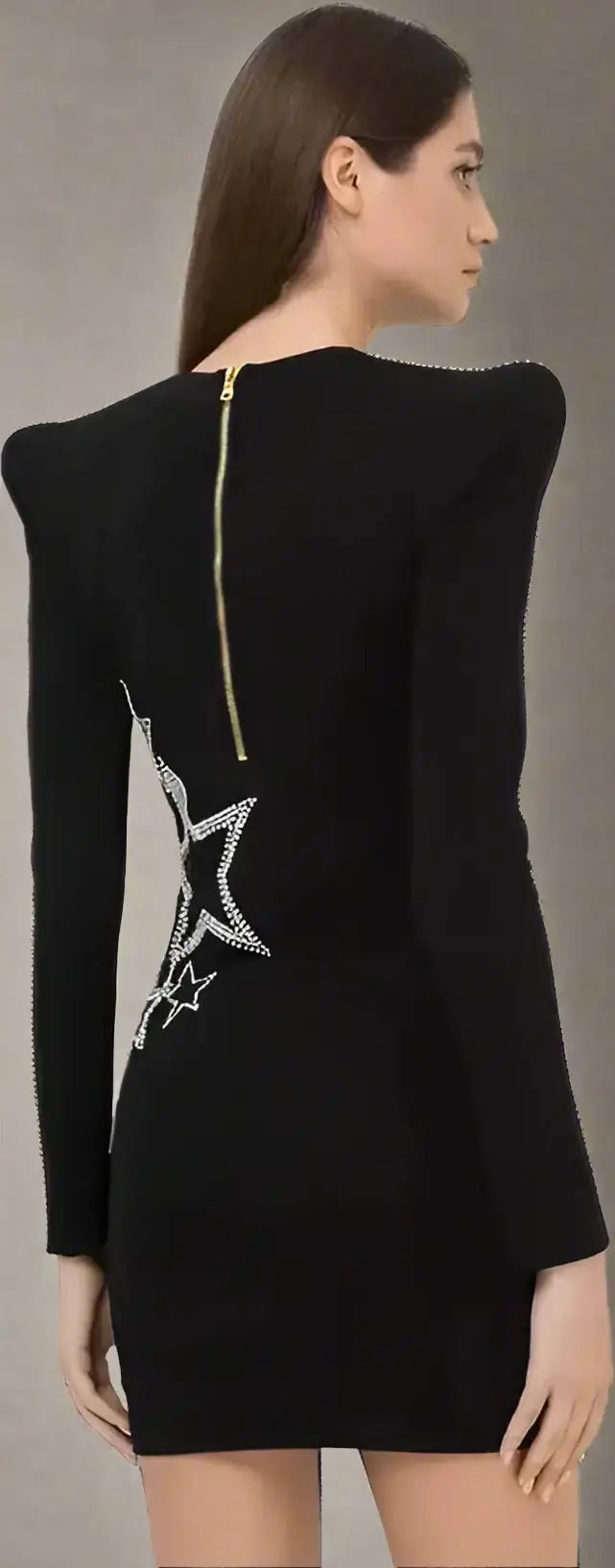 Black viscose dress with white star embellishments, shoulder pads, and gold back zipper