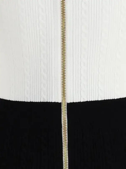 White cable-knit sweater with gold zipper paired with black skirt or trousers for braided pattern midi dress