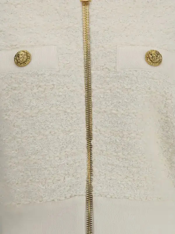 White bouclé tweed bomber jacket with gold zipper and decorative gold buttons