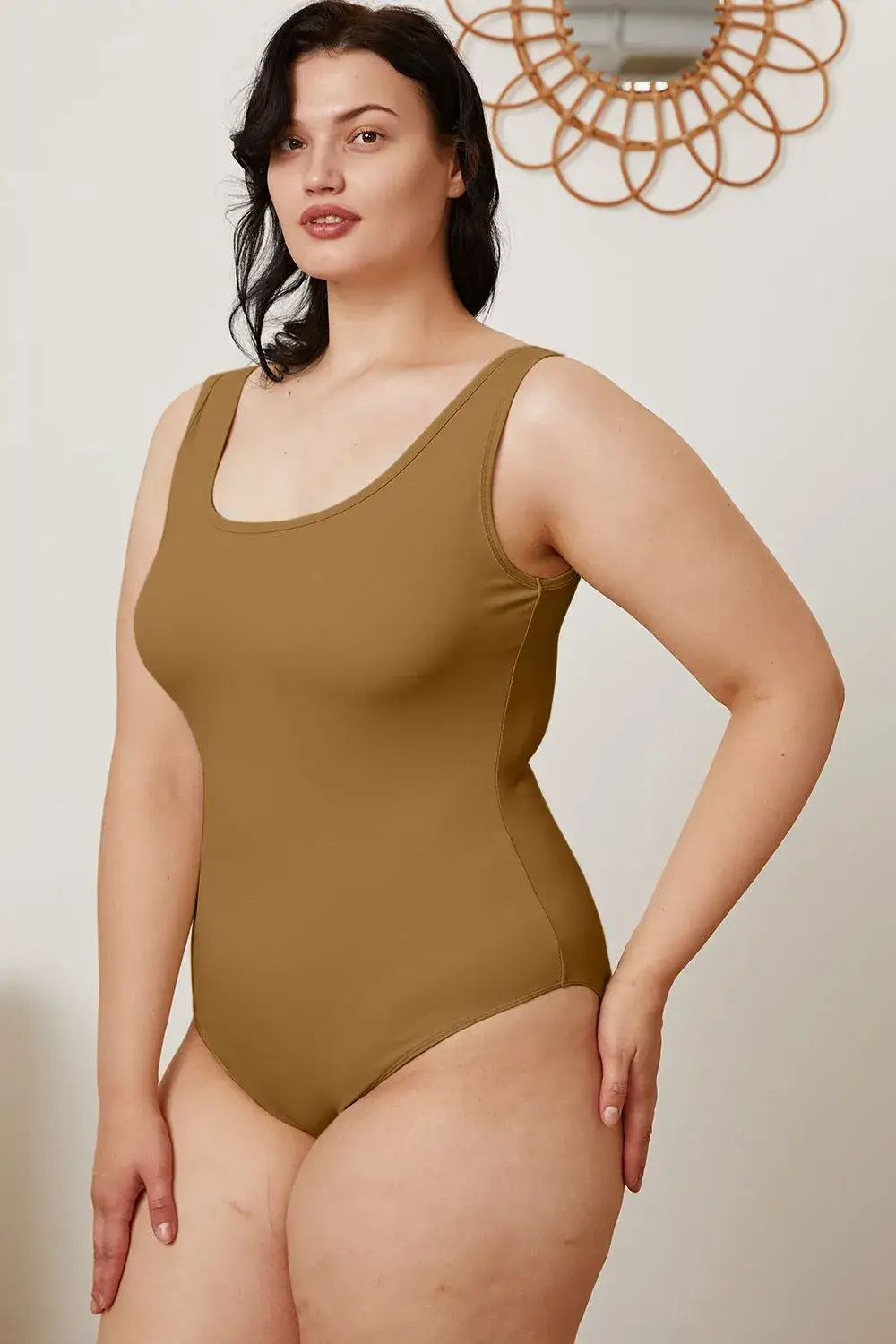 Plus-size woman in solid brown square neck sleeveless bodysuit showcasing size square neck style