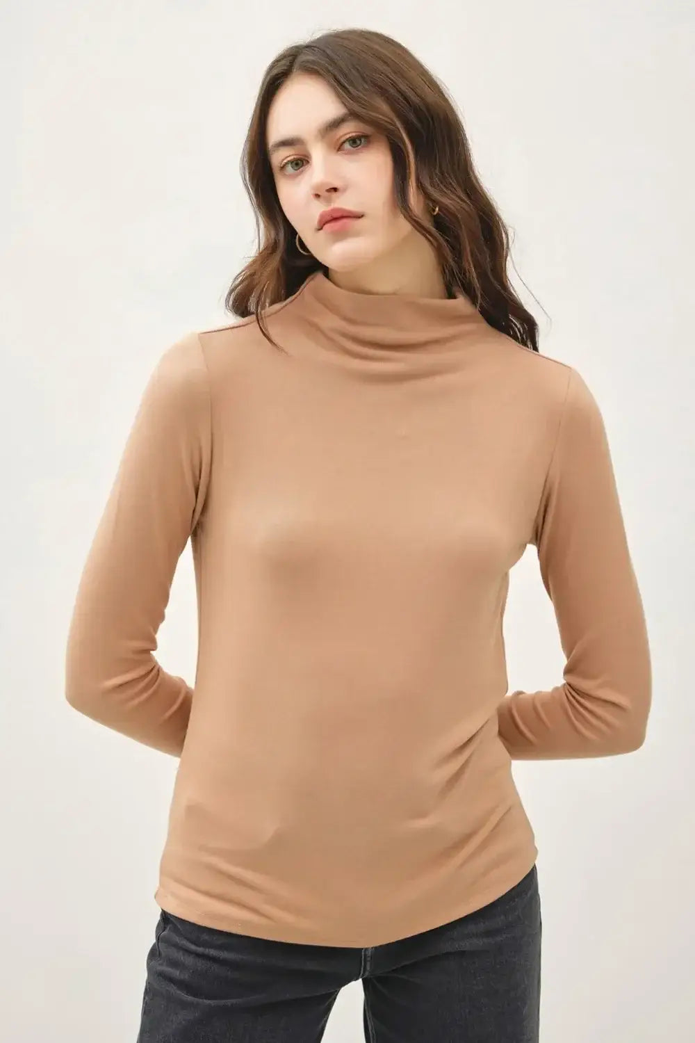 Camel-colored mock neck long sleeve sweater with ribbed cuffs and hem in stretchy knit
