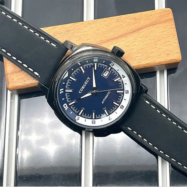 Men’s black leather strap watch with steel black surface, dark blue face, and white markings
