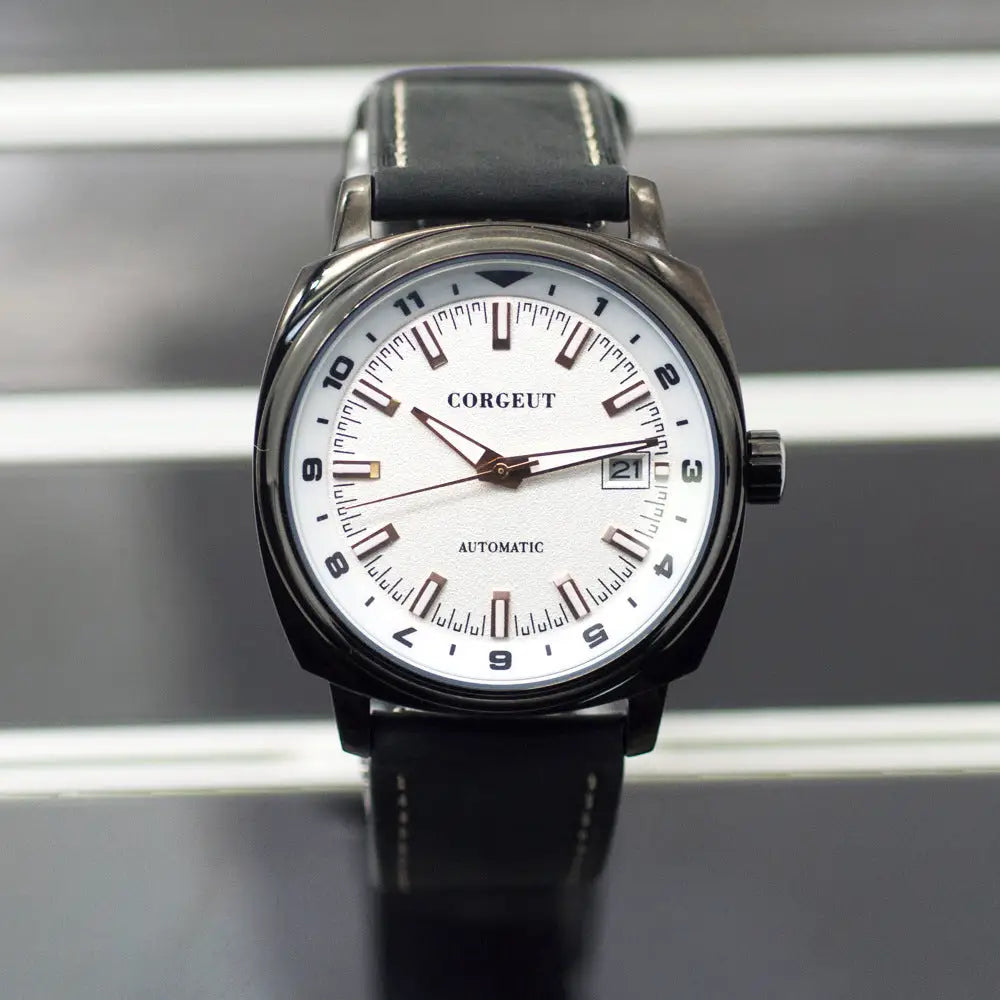 Men’s black leather strap watch with steel black surface, white face, and date display