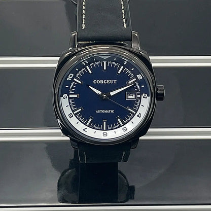 Men’s automatic watch with a dark blue dial and black leather strap on steel black surface