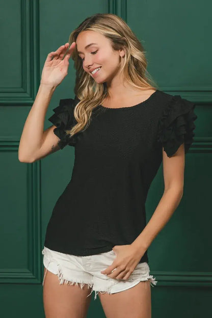 Black birdseye texture layered ruffle top with short sleeves and frayed hem shorts
