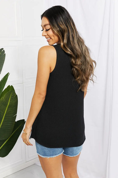Black ribbed tank top from Blumin Apparel Chance paired with denim shorts and wavy hair