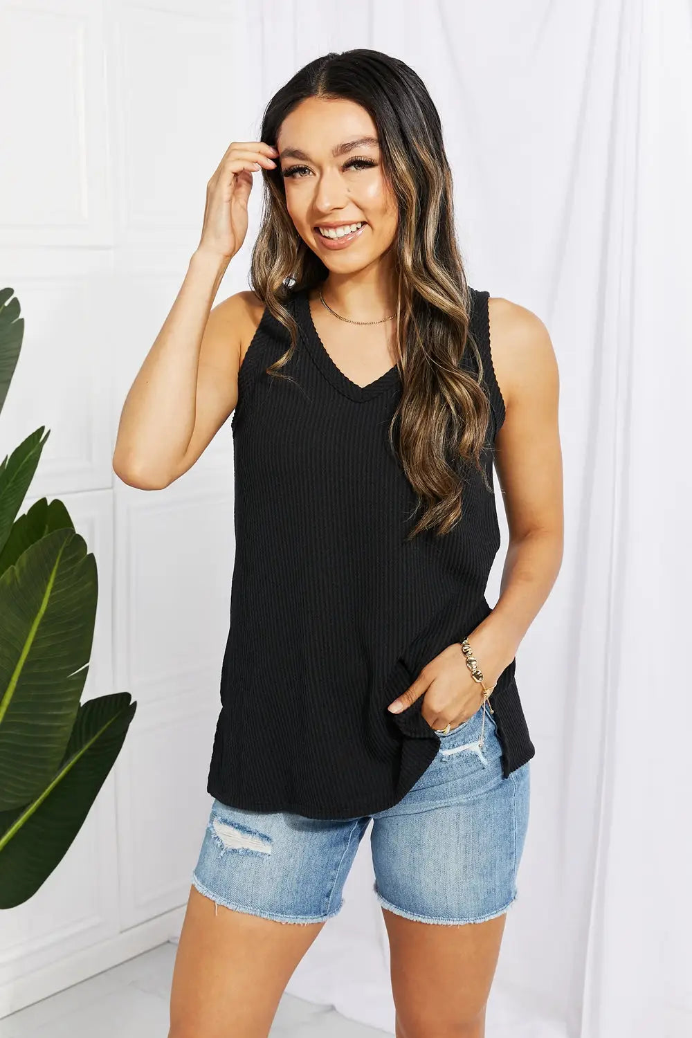 Black ribbed V-neck tank top from Blumin Apparel Chance paired with distressed denim shorts