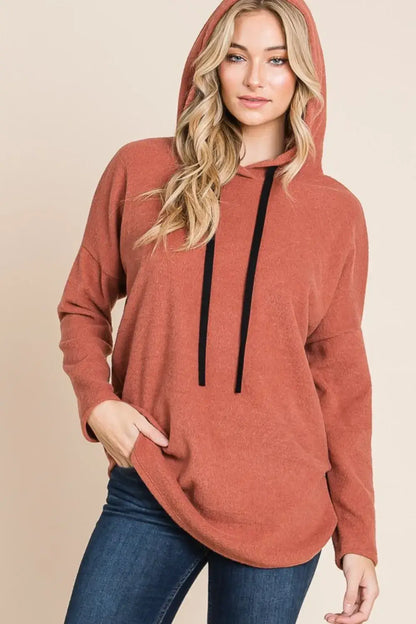 Terracotta knit hoodie with drawstrings and pockets, relaxed-fit knit hoodie style