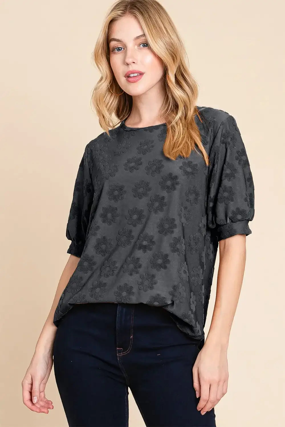 Charcoal floral puff sleeve top with textured floral pattern paired with dark denim jeans
