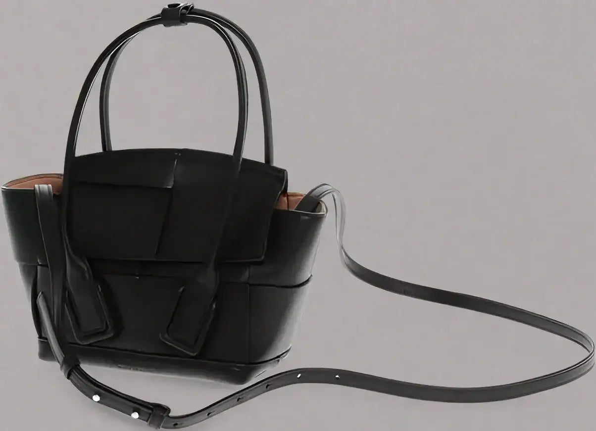 Black leather woven tote bag with removable shoulder strap and top handles by BOTTEGA VENETA