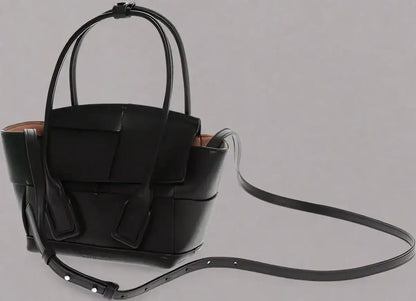 Black leather woven tote bag with removable shoulder strap and top handles by BOTTEGA VENETA