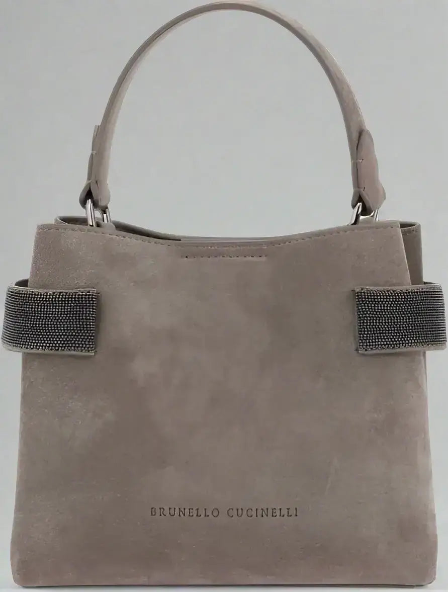Light brown suede leather handbag with top handle and embellished side straps