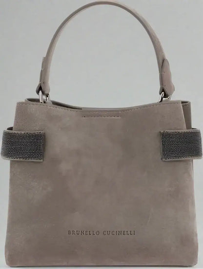 Light brown suede leather handbag with top handle and embellished side straps