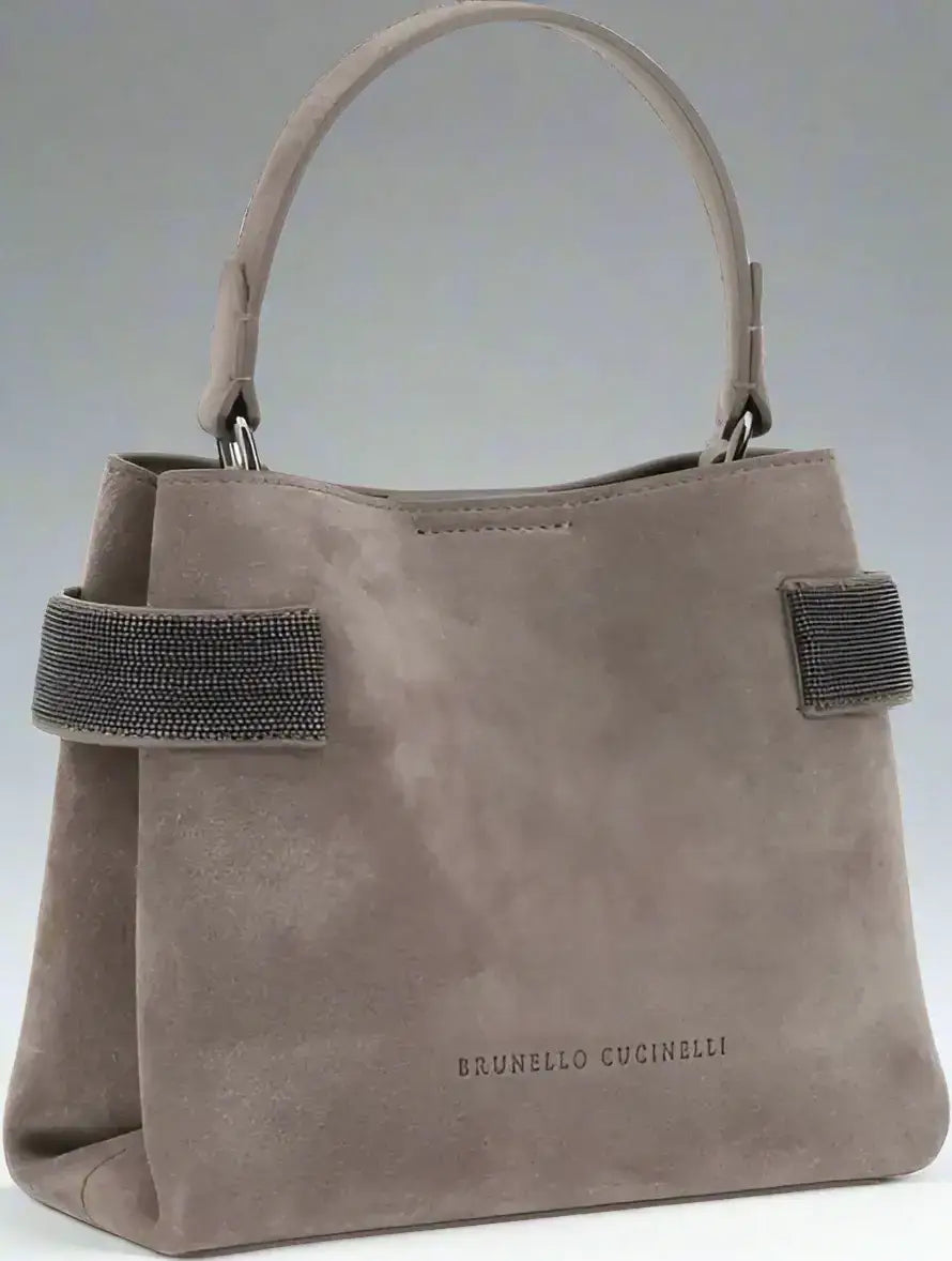 Taupe suede leather handbag with top handle and embellished side straps by Brunello Cucinelli