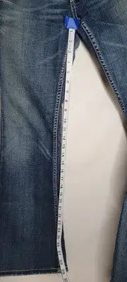 Blue denim jeans being measured with tape for buckle bke denim Sabrina bootcut fit