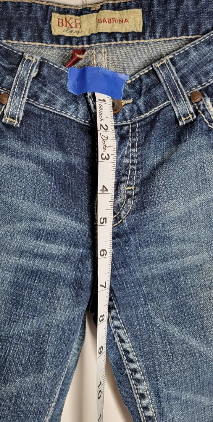 Blue denim jeans with measuring tape showcasing Buckle BKE Denim Sabrina bootcut style