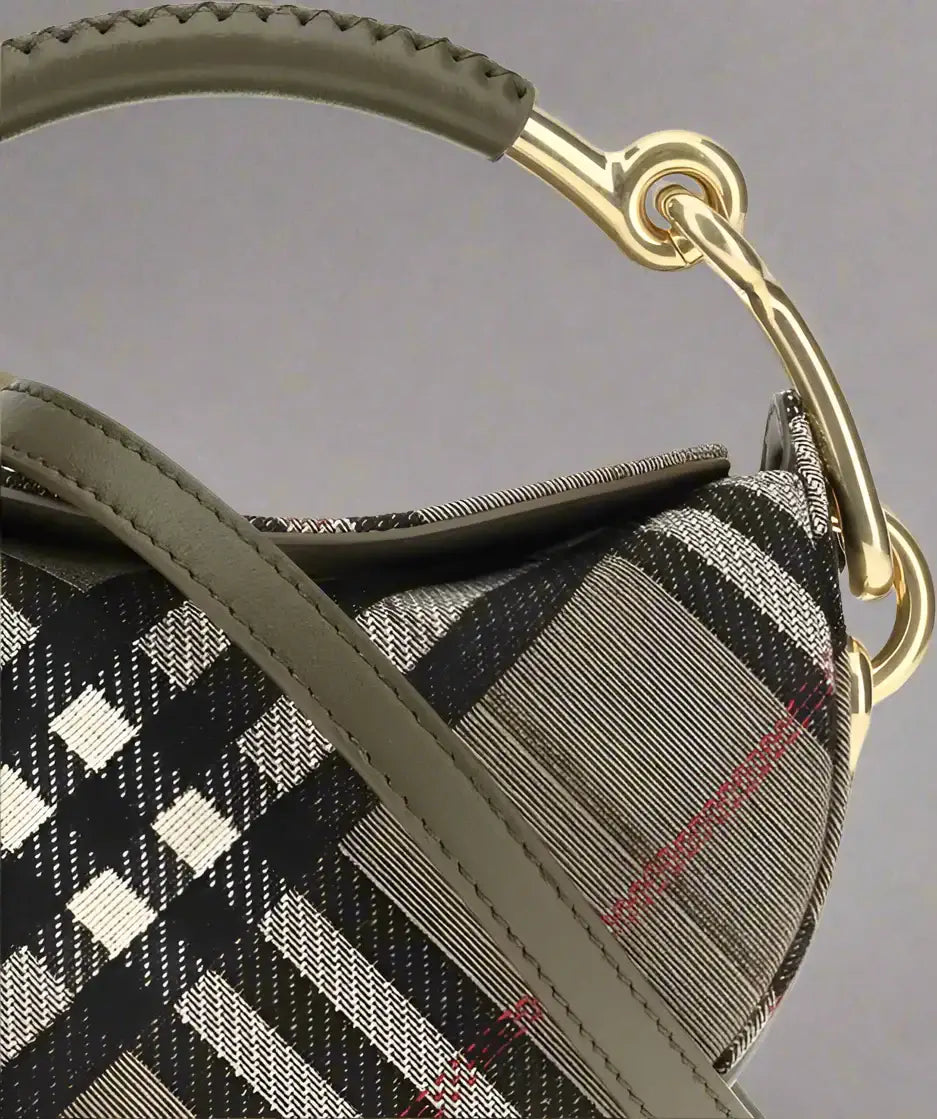 Close-up of a brindle clutch bag with plaid design and gold metal handle for women
