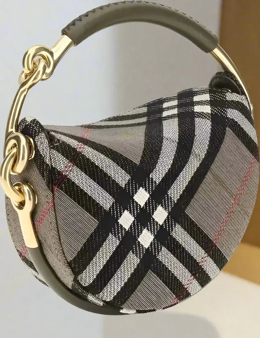 Brindle clutch bag with patterned crescent shape, gold chain, and dark handle