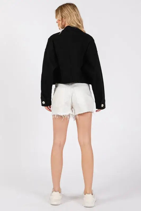 Black cropped denim jacket with button details and fringe white denim shorts