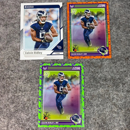 Three Calvin Ridley NFL trading cards, two with Halloween themes, in Tennessee Titans 2024 set