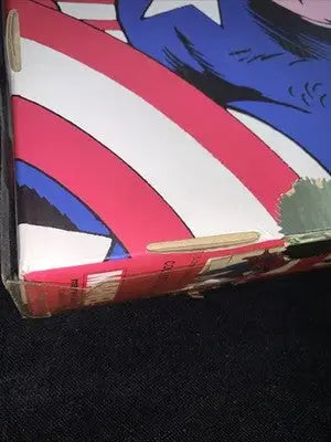 Rectangular box with American flag design, red and white stripes, blue star section, worn edge