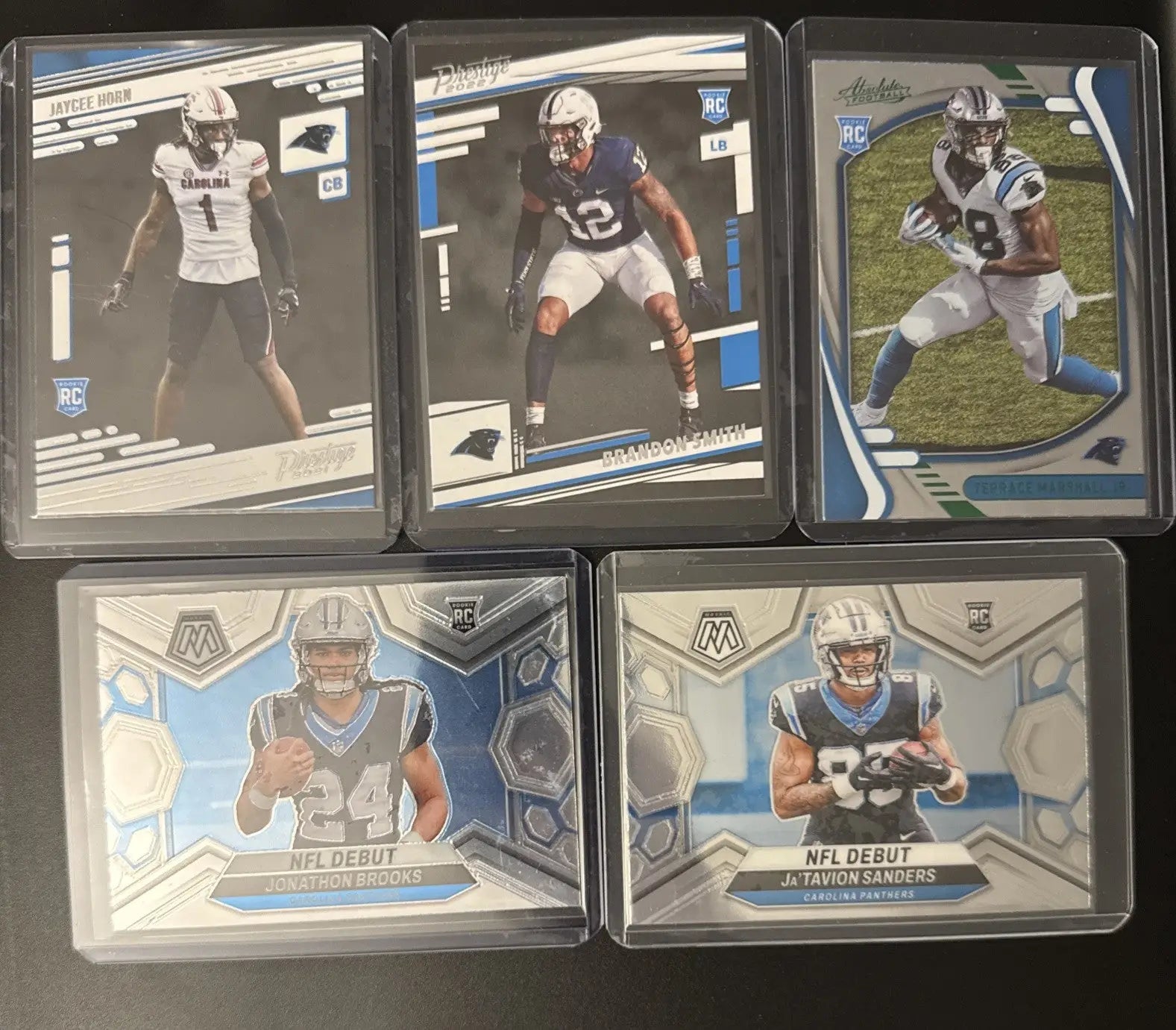 Five collectible Carolina Panthers trading cards rookie lot featuring Young Brooks Sanders Legette