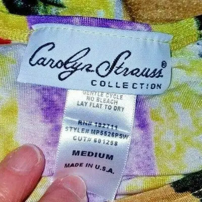 Clothing label with care, size medium, and brand details for Carolyn Strauss pullover blouse