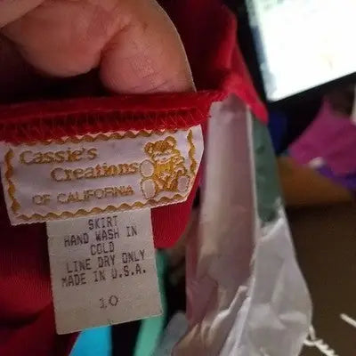 Red velvet garment label with care instructions on Cassie’s Creations Size 10 Red Velvet Empire Waist Dress