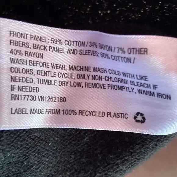 Care and fiber content label on Cat & Jack Girl’s Black Silver Star Pattern clothing