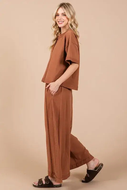 Brown linen jumpsuit with half button half sleeve design, relaxed fit wide-leg pants