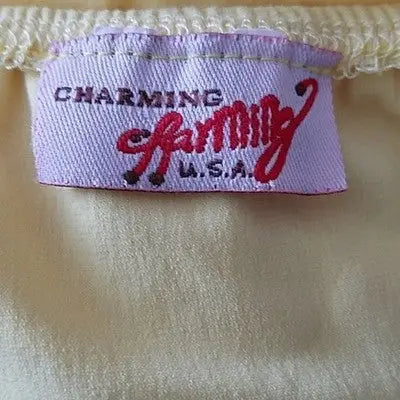 Light pink fabric clothing label with red embroidery on Charming Women’s Yellow Halter Sundress size small