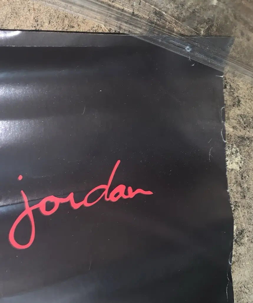 Black poster with red Jordan script featuring Chicago Bulls sports memorabilia artwork