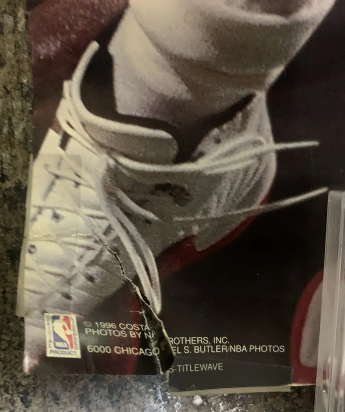 Damaged Chicago Bulls poster featuring Michael Jordan basketball shoe sports memorabilia