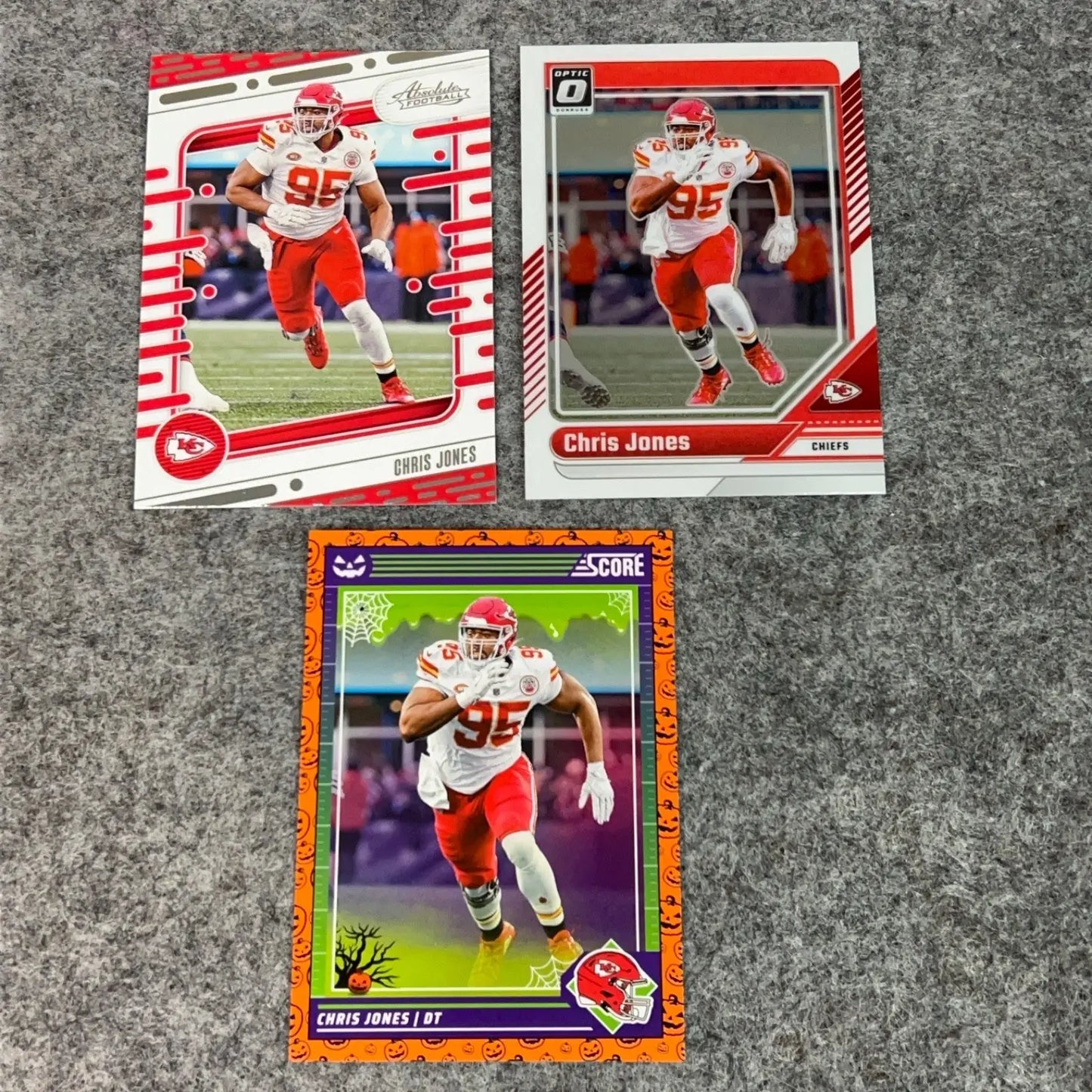 Three Chris Jones Kansas City Chiefs 2024 NFL football trading cards displayed